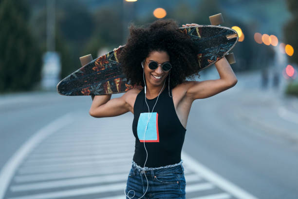 A young woman skateboarding.