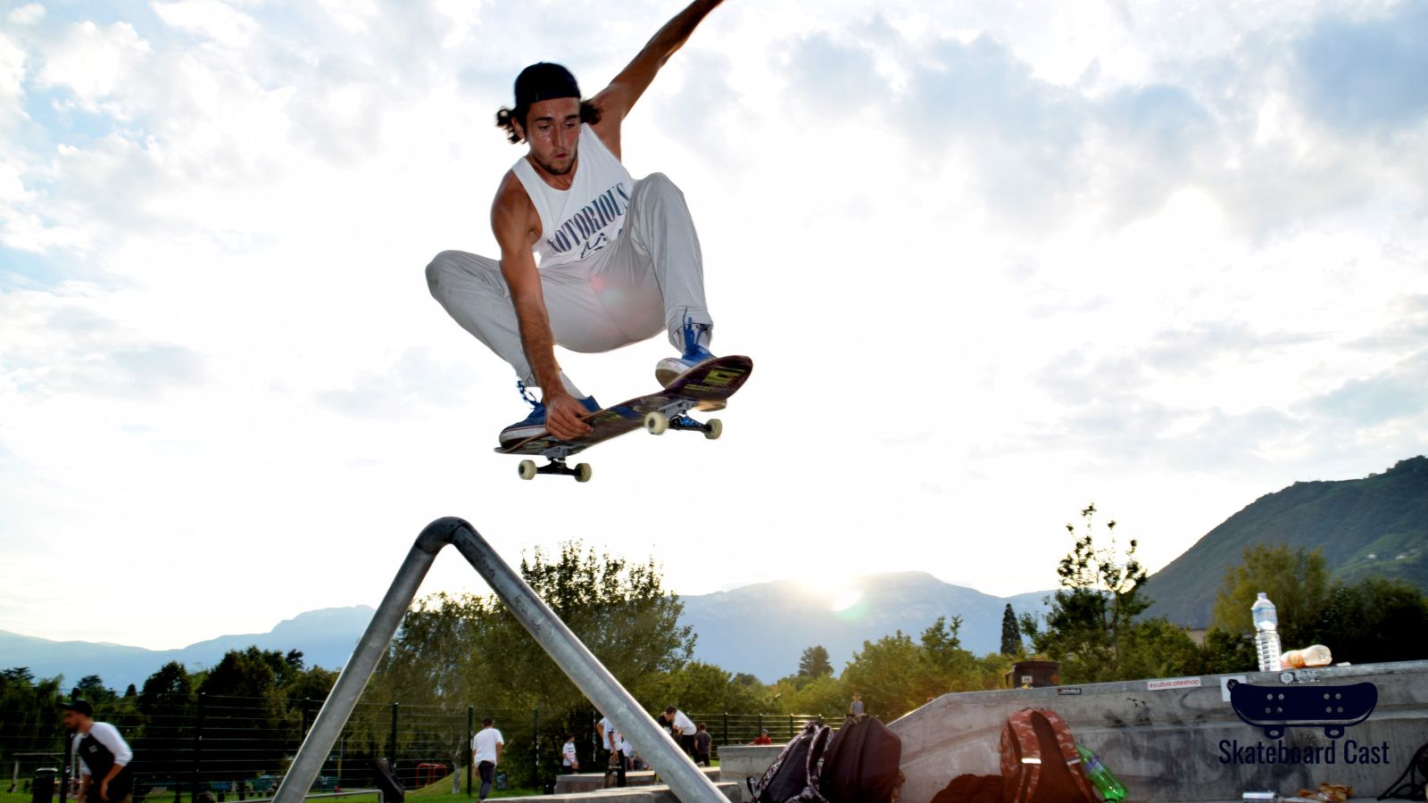 A skateboarder doing a trick in the air on their skateboard.